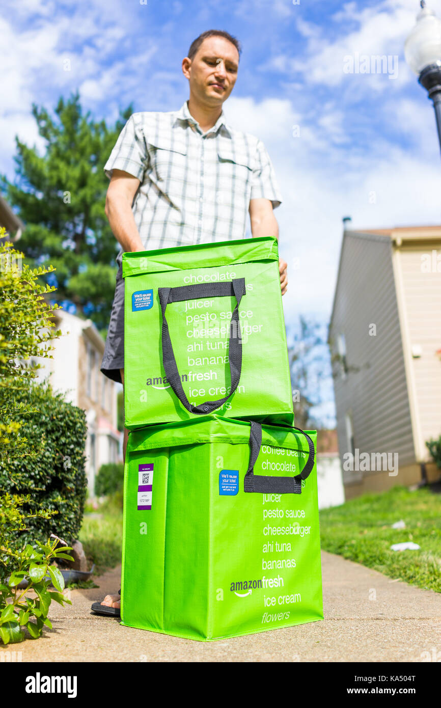 Fairfax, USA - 12. September 2017: Amazon Frisch isolierte Lebensmittel-lieferservice  Taschen Taschen auf der Vorderseite Home Haus Veranda closeup mit Mann  suche schließenden Deckel Stockfotografie - Alamy