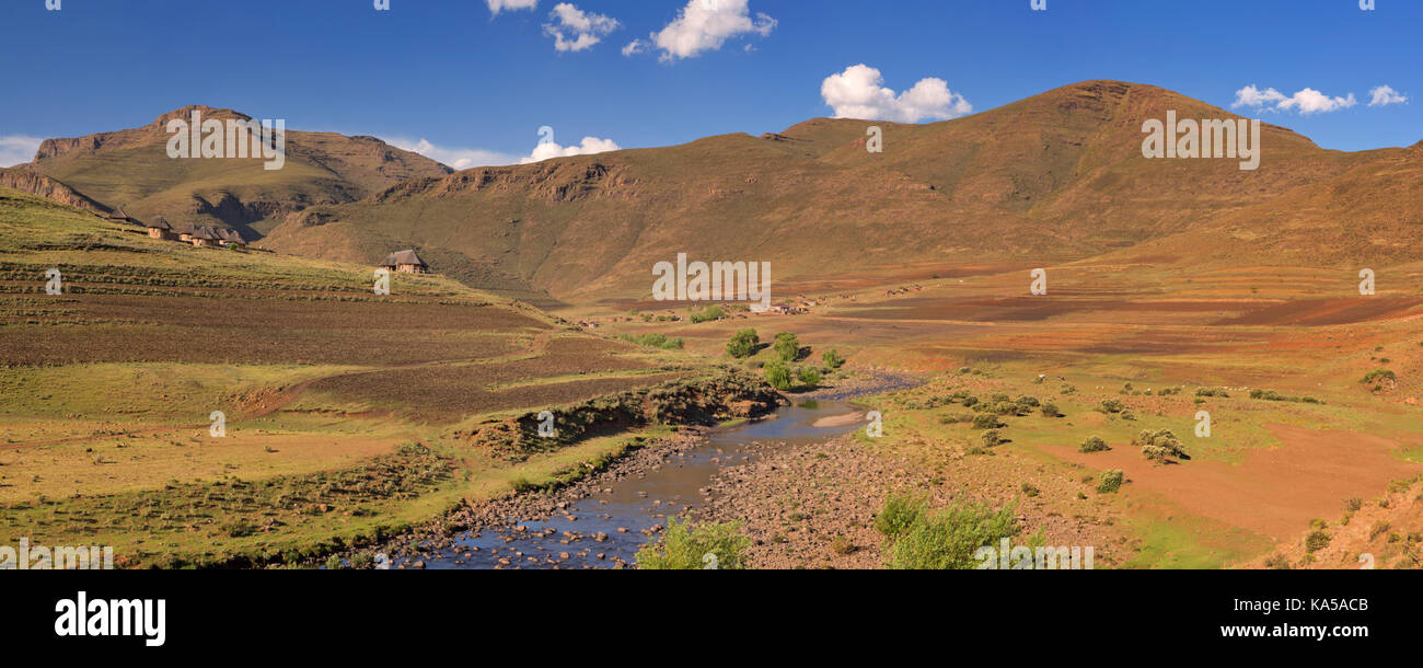Ein traditionelles Dorf entlang eines Flusses in den Bergen von Lesotho. Stockfoto