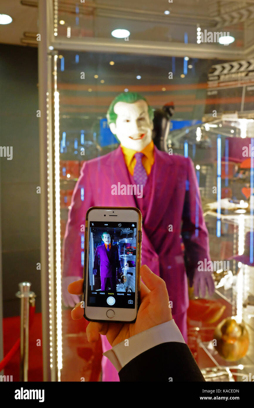 /Person nimmt Smartphone Foto der Joker Kostüm getragen von Jack Nicholson im Film Batman, die für € 32.500 an der Auktion am BFI IMAX verkauft Stockfoto