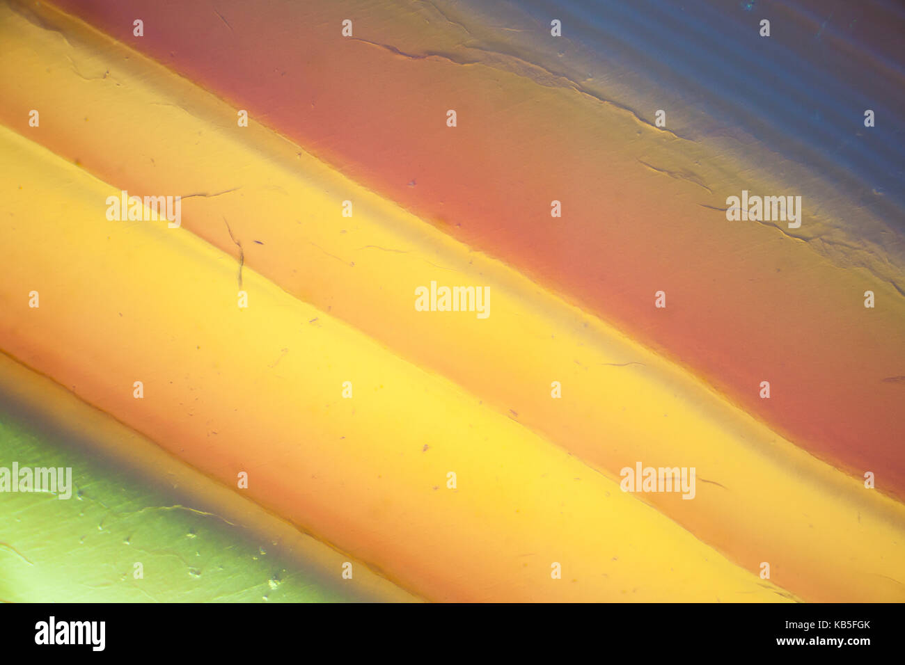 Zusammenfassung Hintergrund - gelb orange grün Achat Scheibe mineral Makrofotografie Vergrößerung x 400 Stockfoto