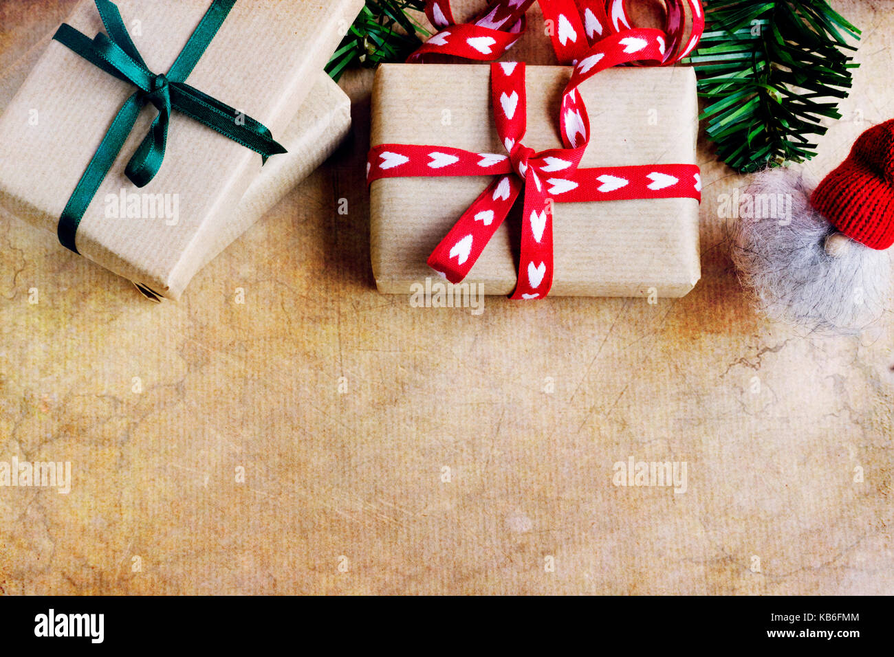 Die Gemeinkosten der rustikale Geschenke mit Herz Form und grünen Bändern, elf auf abstrakten Hintergrund. Kopieren Sie Platz. Gegenstand gegen weiche Fenster Beleuchtung erfasst. Stockfoto