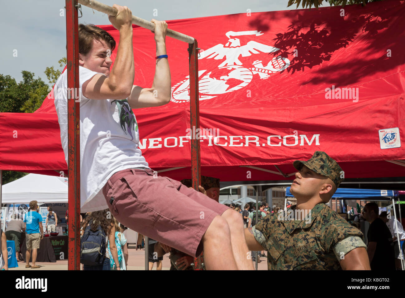 Fort Collins, Colorado - Auf dem Campus der Colorado State University, eine Marine recruiter Uhren ein Student tun chin-ups. Stockfoto