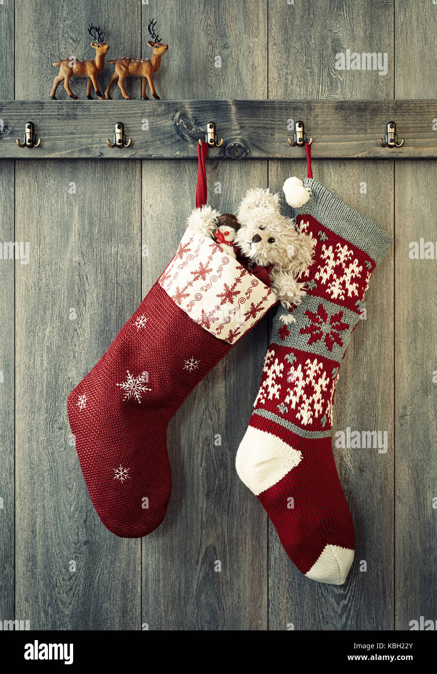 Paar Weihnachten Strümpfe hängen an Haken mit Rentier zahlen sitzt auf der Kante Stockfoto