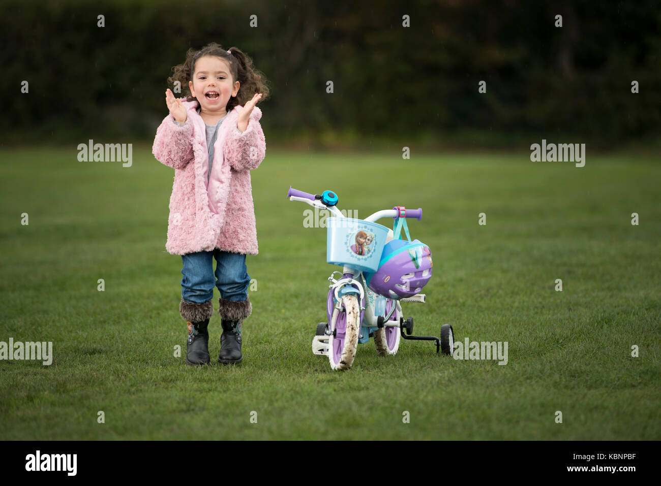 Hübsche junge Mädchen auf ihrem Disney Fahrrad im Park posieren. Kredit LEE RAMSDEN/ALAMY Stockfoto