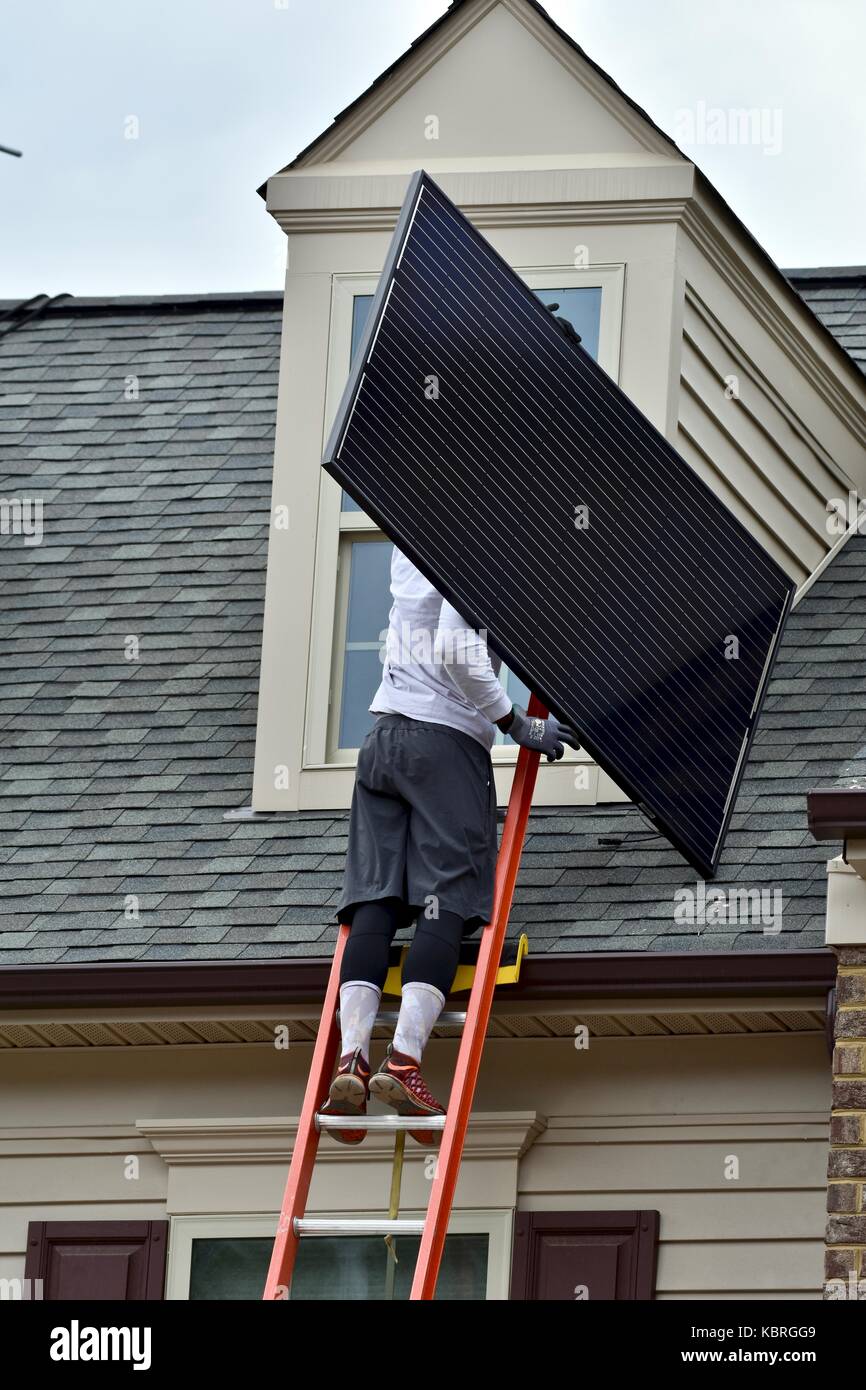 Solar Panel Techniker mit Solarmodulen bis Leiter auf das Dach eines Hauses  Stockfotografie - Alamy