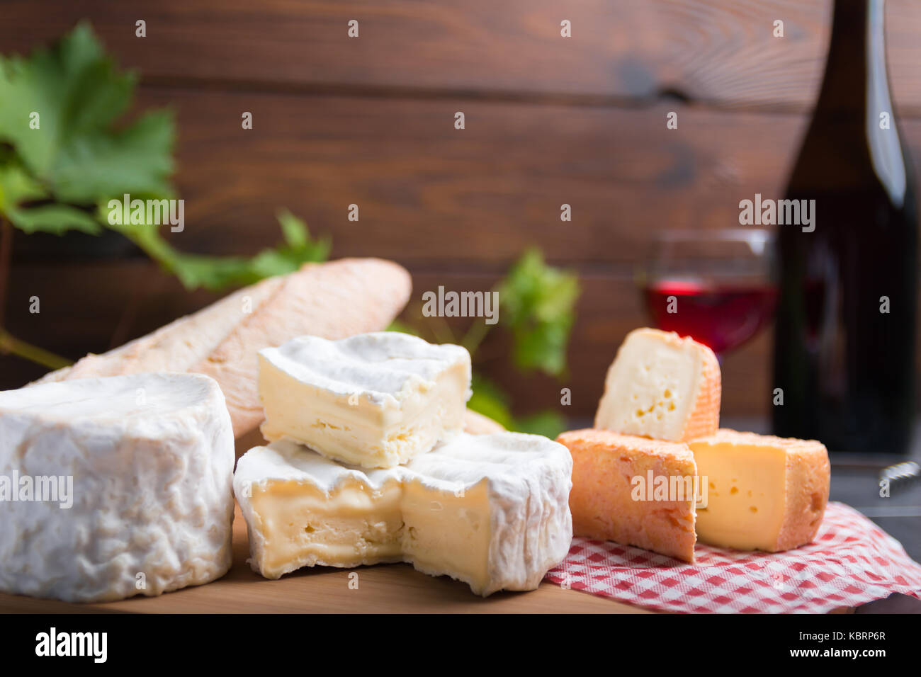 Variation von Käse, Wein und Brot auf einem Tisch aus Stein Stockfoto