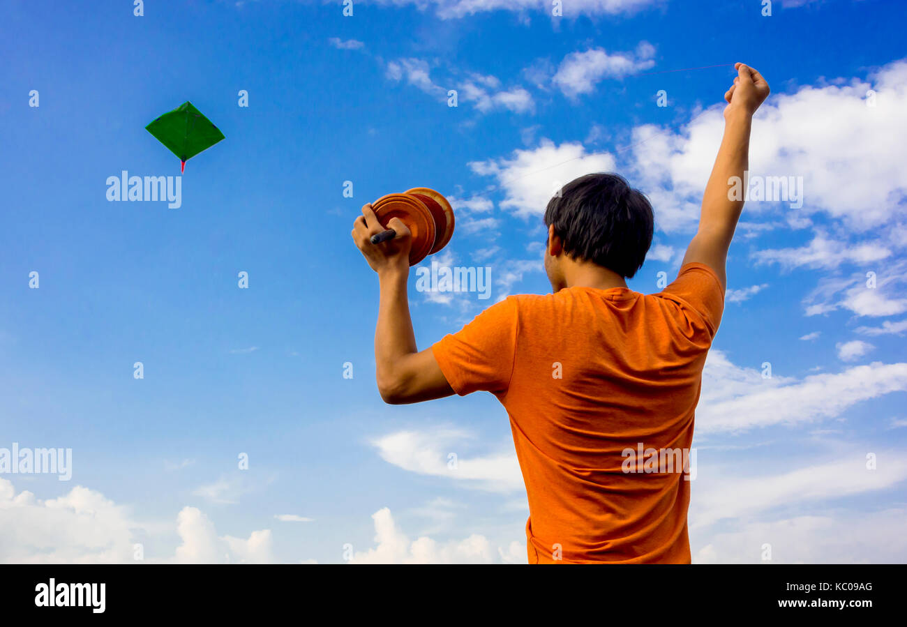 Ein Kerl fliegende Drachen mit blauen Himmel im Hintergrund und Copyspace Stockfoto