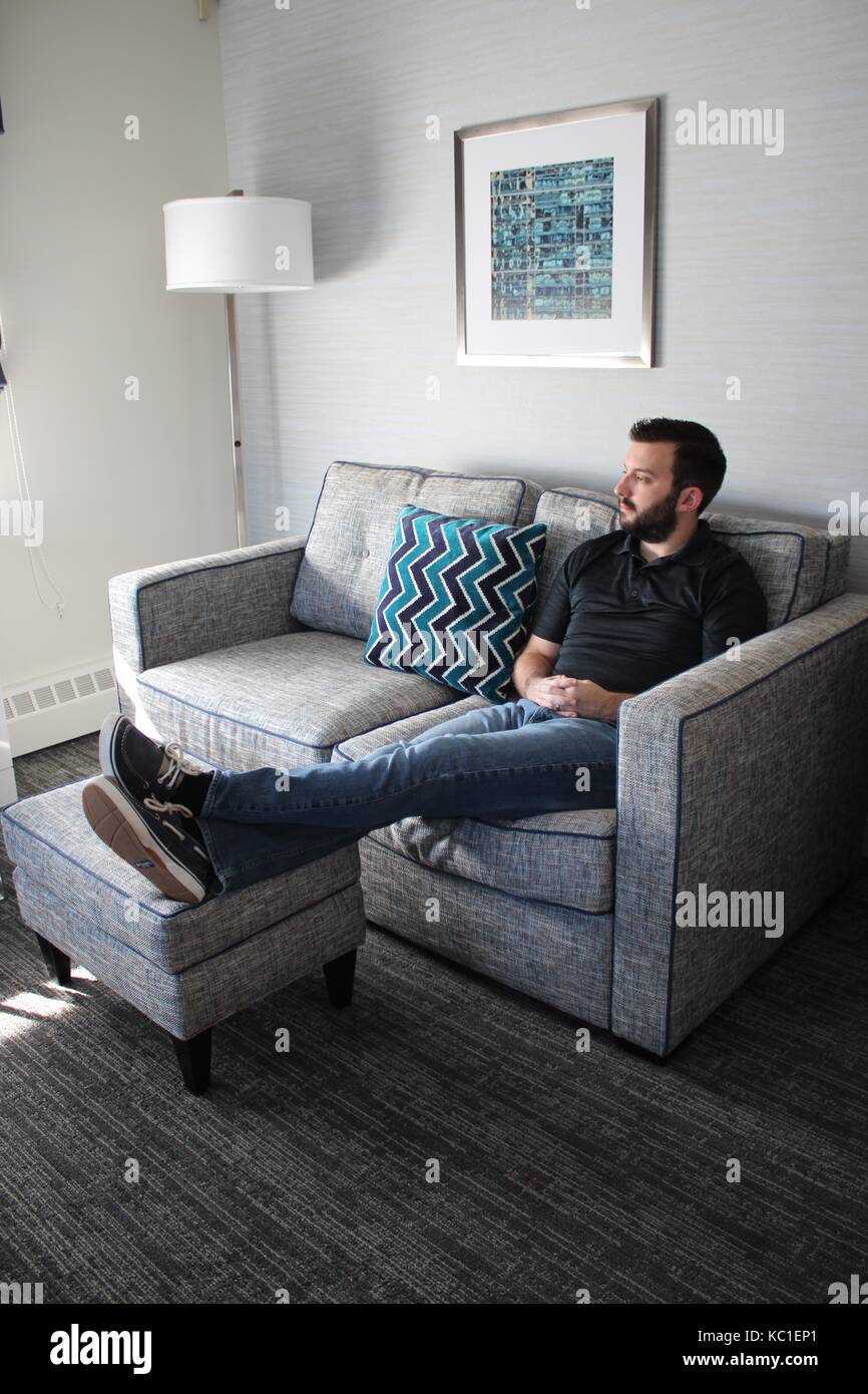 Mann auf dem Sofa Denken und Entspannend Stockfoto