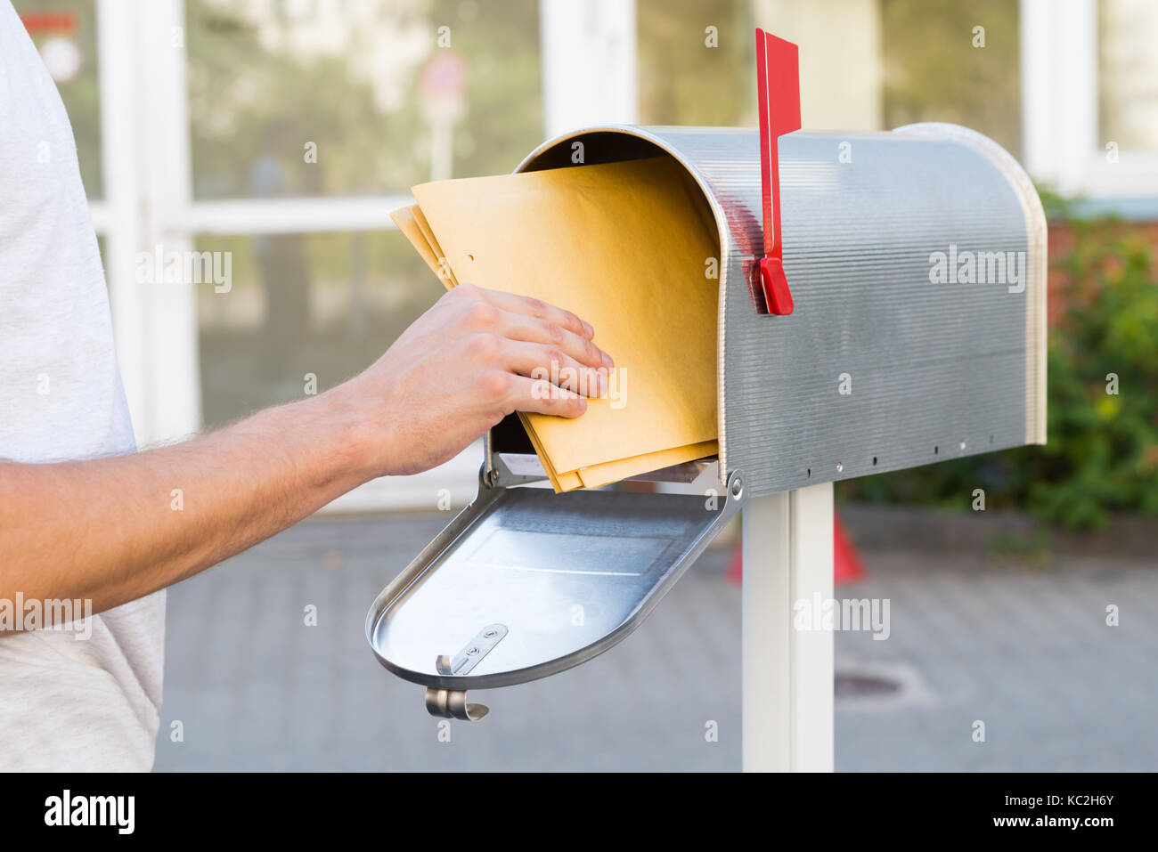 Nahaufnahme der Person Entfernen gelbe Buchstaben aus der Mailbox Stockfoto
