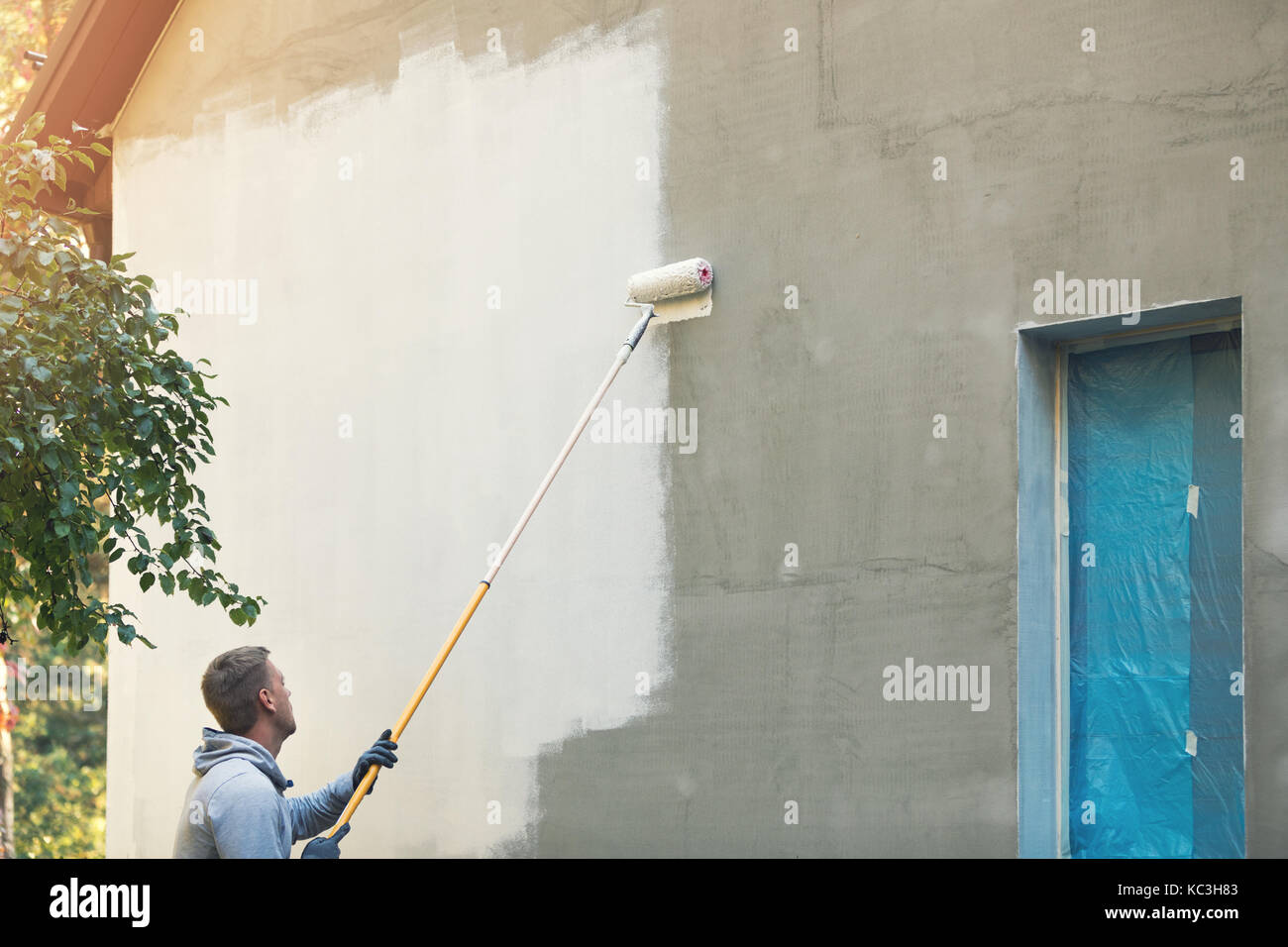 Haus Maler Malerei Gebäude Exterieur mit Rolle Stockfoto