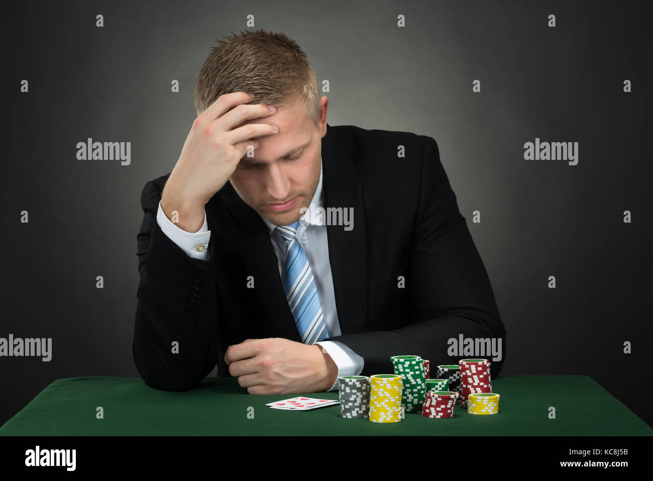 Deprimiert männlich Poker mit Chips und Karten auf dem Tisch Stockfoto