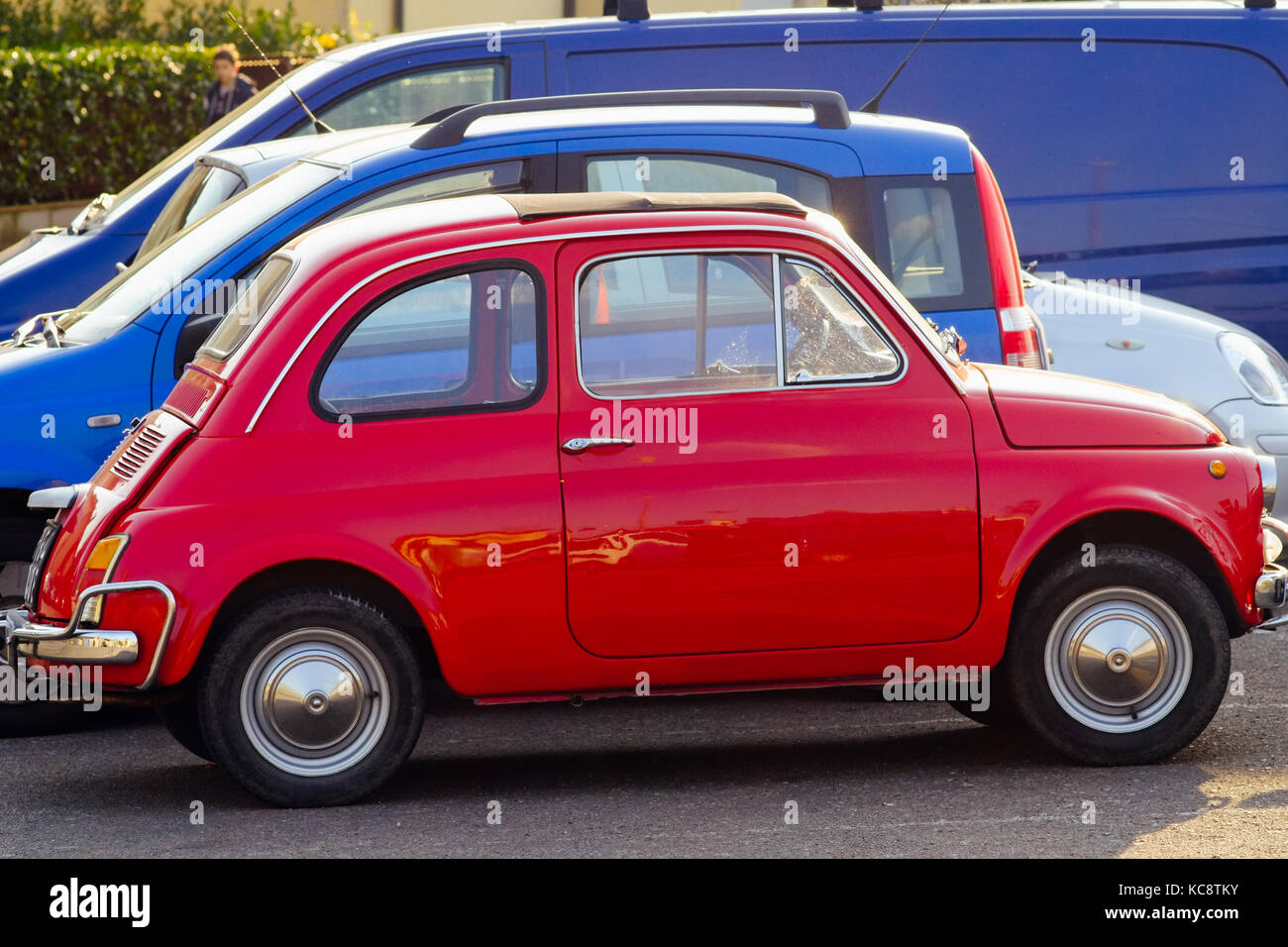 Rot Fiat 500 in der Nähe von Blue Autos auf der Straße geparkt. Classic vintage Modell. Florenz, Italien Stockfoto
