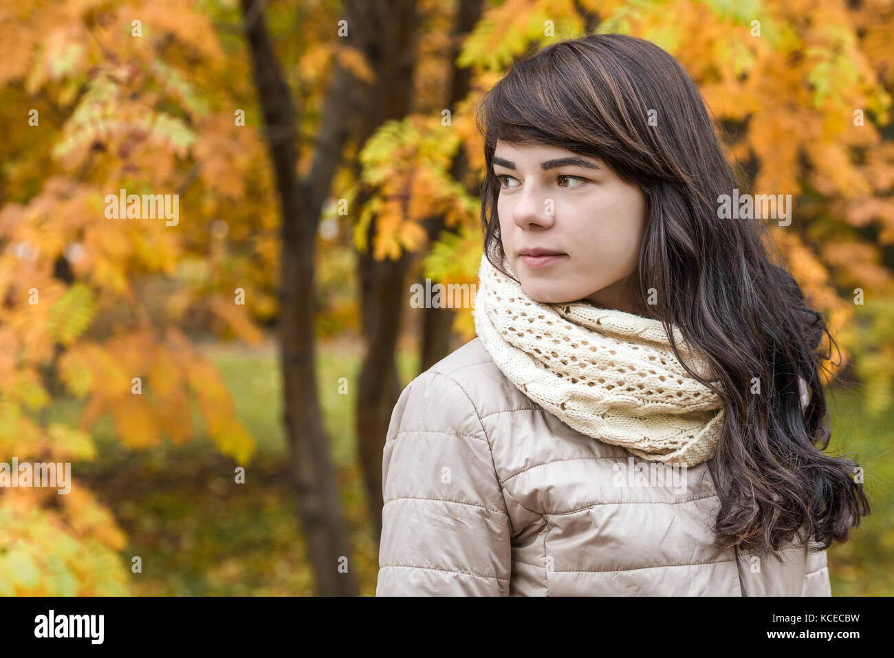 Mädchen mit dunklen lockigen Haar vor dem Hintergrund der im Herbst Laub Stockfoto