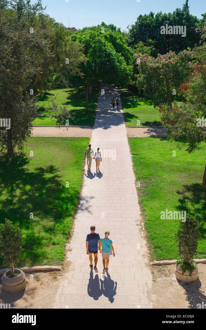 Paartrek, an einem Sonntagmorgen im Sommer spazierengehen Paare durch den Turia Flussbetgarten - die Jardines del Turia - in Valencia, Spanien. Stockfoto