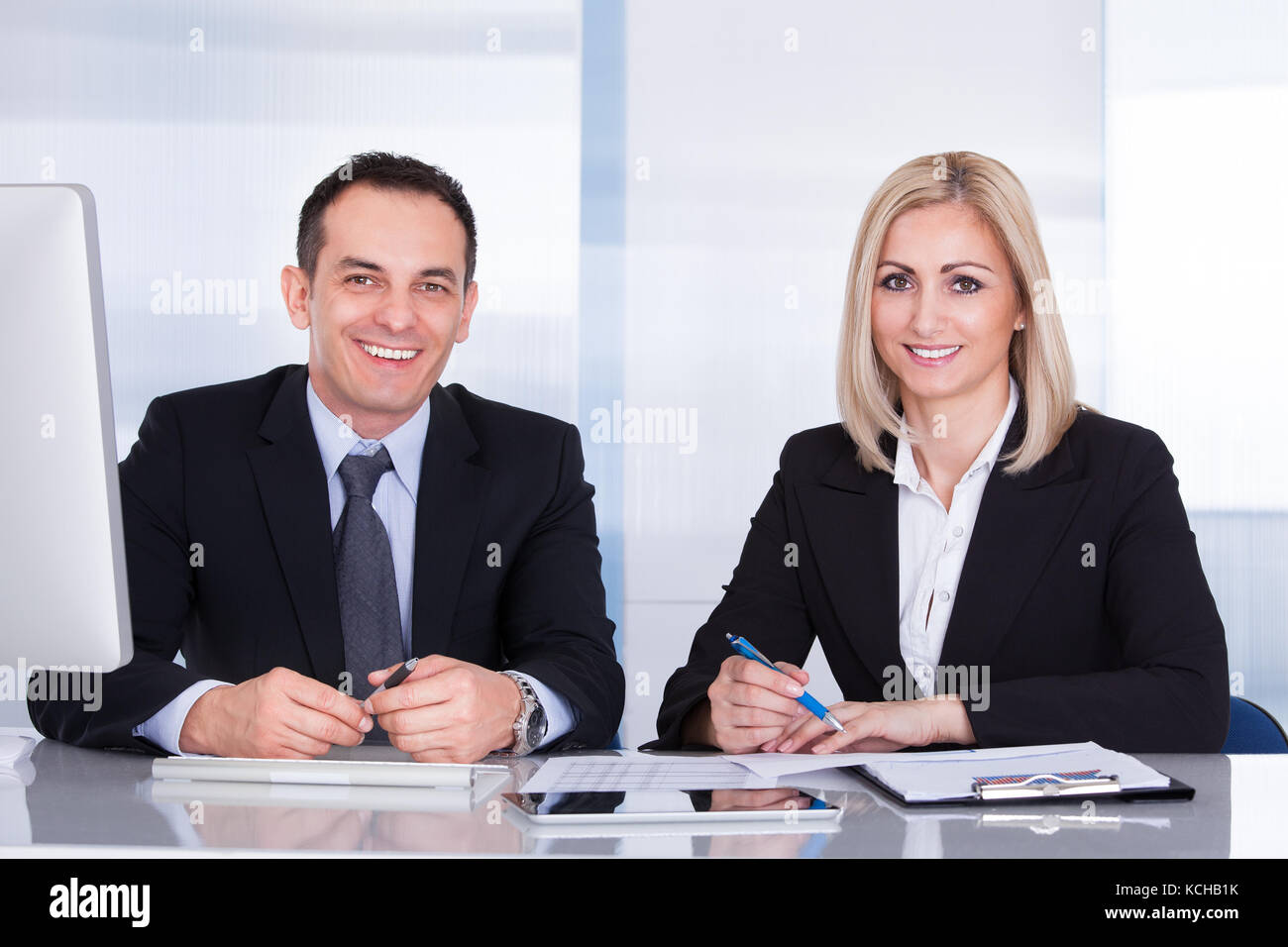 Porträt von zwei glücklichen Kollegen im Büro arbeiten zusammen Stockfoto
