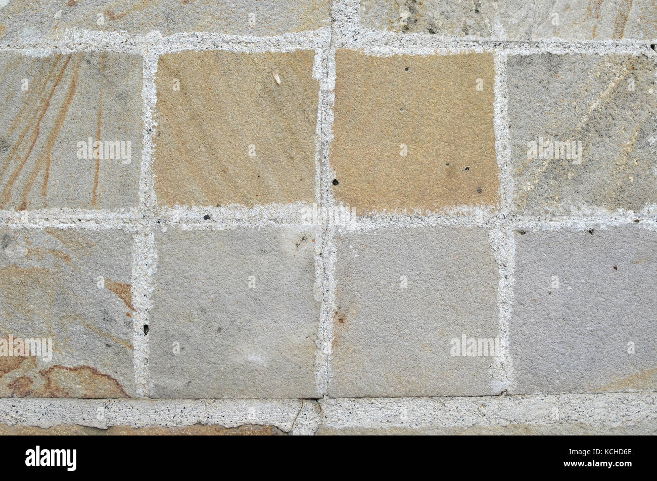 Grau und warme Farbe ashlars Oberfläche mit Zement zwischen ihnen Stockfoto