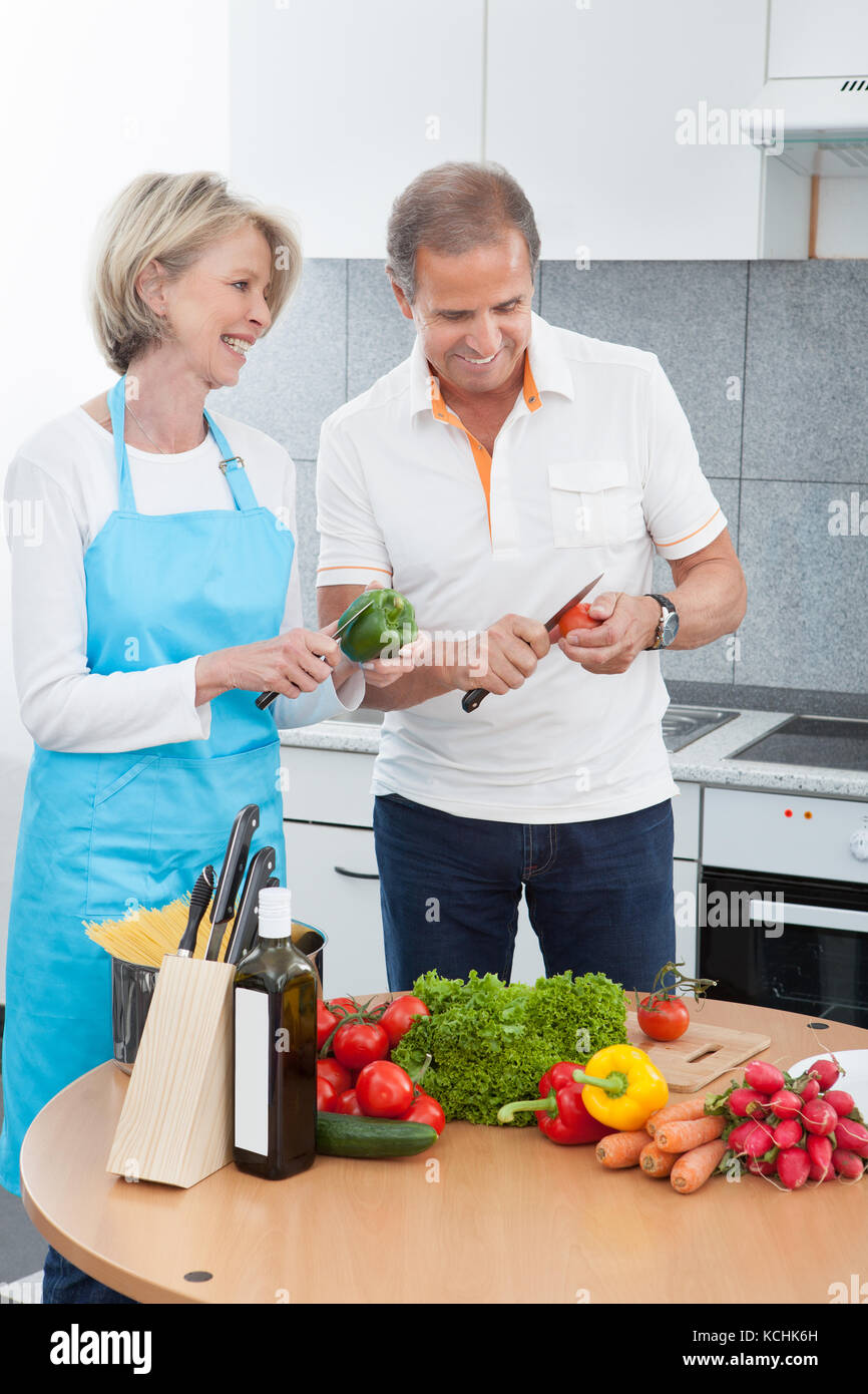 Reifer Mann Und Frau Schneiden Gemüse In Der Küche Stockfoto