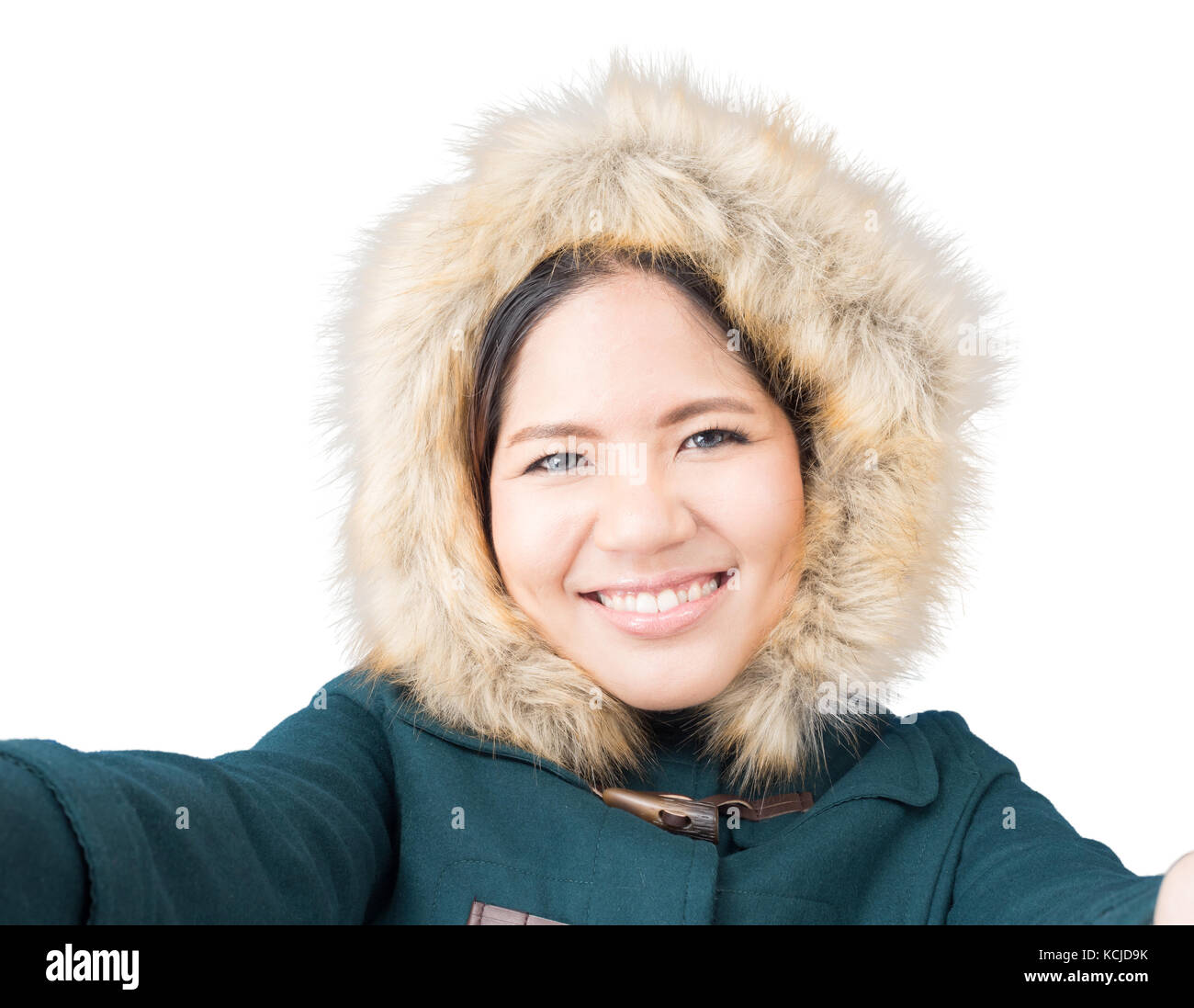 Asiatische Frau mit grünen Mantel mit Fell Hut isoliert auf weiss Stockfoto