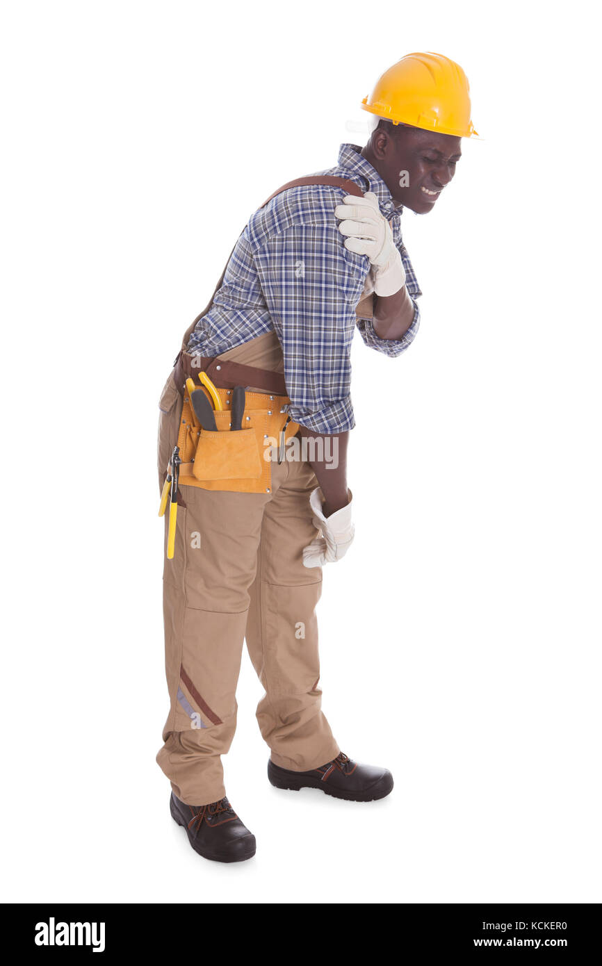 Männliche Handwerker leiden unter Schmerzen in der Schulter Over White Background Stockfoto