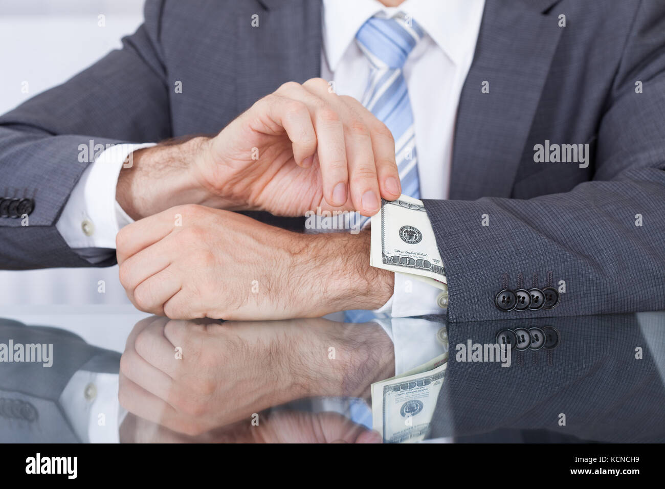 Nahaufnahme der Unternehmer ziehen Out Banknote aus Ärmel am Arbeitsplatz Stockfoto