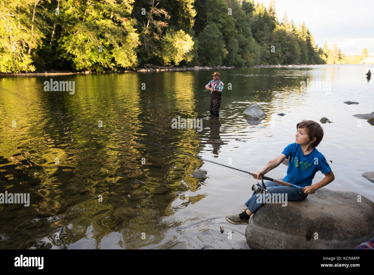 Ein junger Fischer, der einen Lachs fangen will, wirft in den Campbell River auf Vancouver Island. Stockfoto
