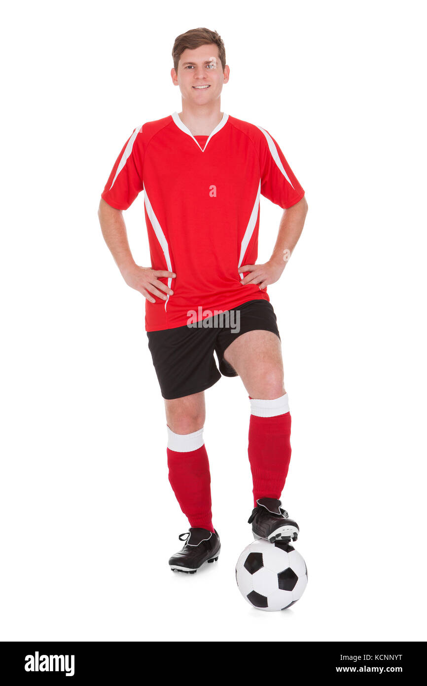 Junge glücklich Fußballspieler, Fußball Over White Background Stockfoto