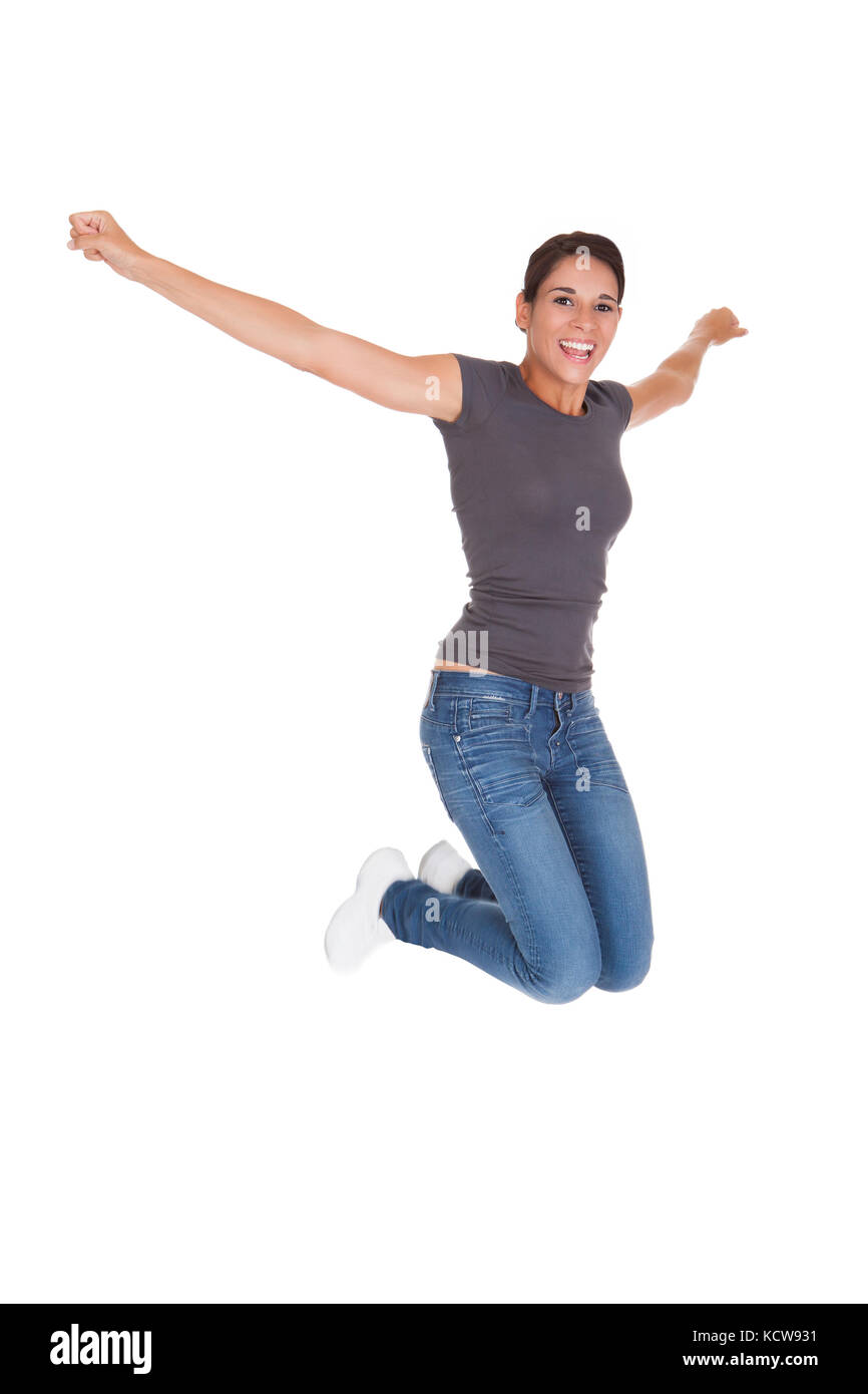 Schöne Frau In Freizeitkleidung Erhöhung Arm Over White Background Stockfoto