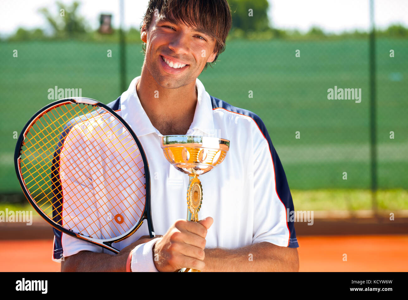 Glück Tennisspieler mit Medaille und Pokal Stockfoto