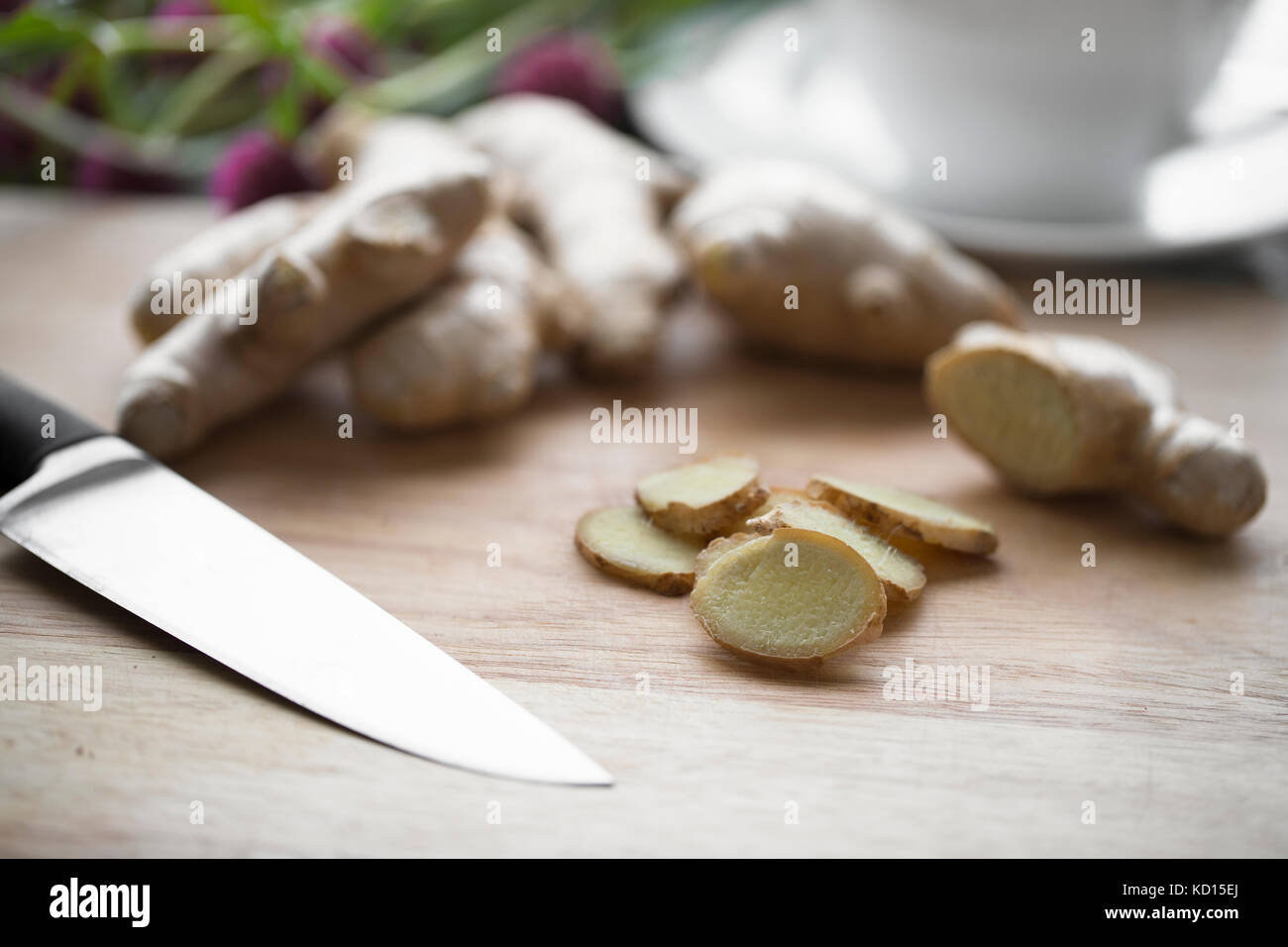 Ingwerwurzel und Ingwer Scheiben mit Messer auf Schneidebrett. Stockfoto