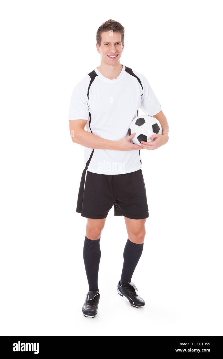 Glückliche junge männliche Fußballspieler, Fußball Over White Background Stockfoto