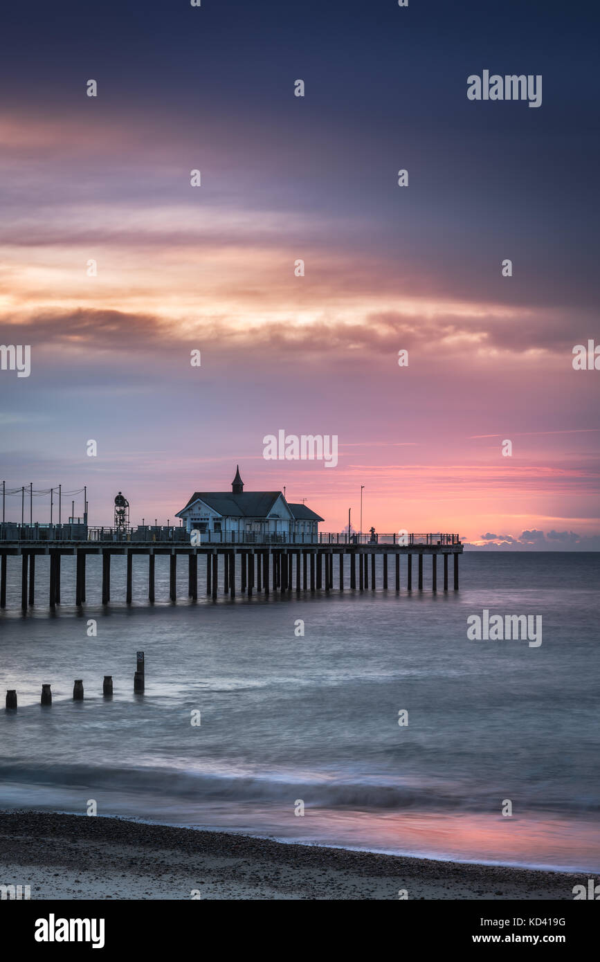 Die Sonne geht hinter Southwold Pier, an der Küste von Suffolk, in der Dämmerung, der Anfang Oktober. Stockfoto