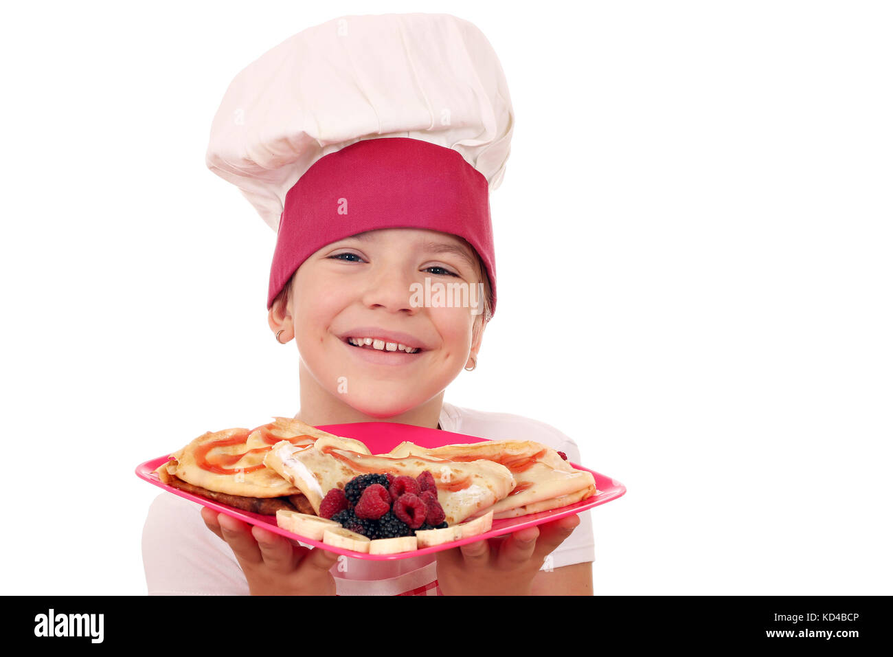 Gerne kleine Mädchen Kochen mit Crepes portrait Stockfoto