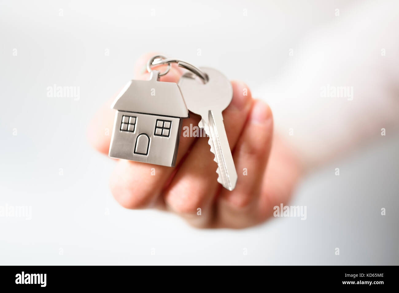 Die hausschlüssel auf Haus geformte Schlüsselbund Konzept für den Kauf einer neuen Heimat Stockfoto