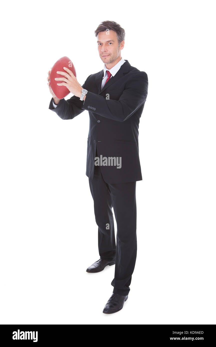 Portrait von Reifen Geschäftsmann Holding rugby ball auf weißem Hintergrund Stockfoto