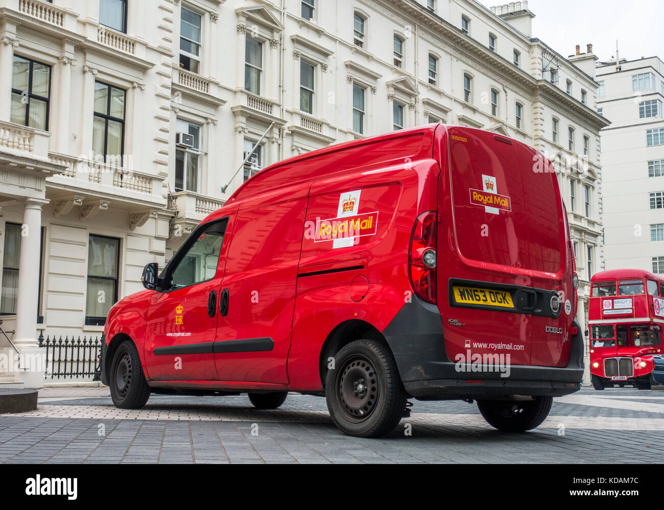 Royal Mail van in einer Straße geparkt, außerhalb der Gebäude, in South Kensington, mit einem traditionellen roten Bus nähern. London SW7, England, UK. Stockfoto