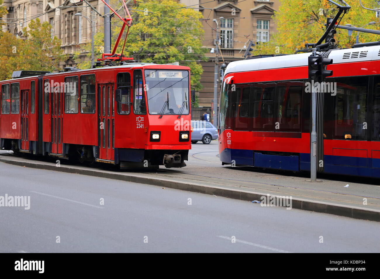 Alte rote Tatra kt4 Straßenbahn- und neuen Caf urbos 3 Straßenbahn auf den Straßen von Belgrad, Serbien Stockfoto