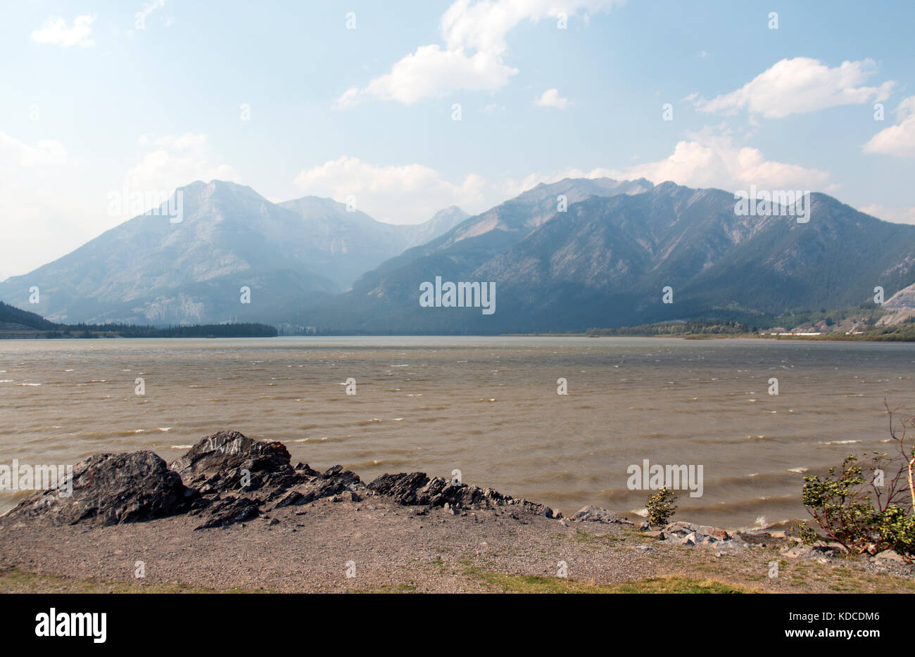 Berge durch den Dunst der Wald Feuer Rauch an den Ufern des Bow River in Alberta, Kanada. Stockfoto