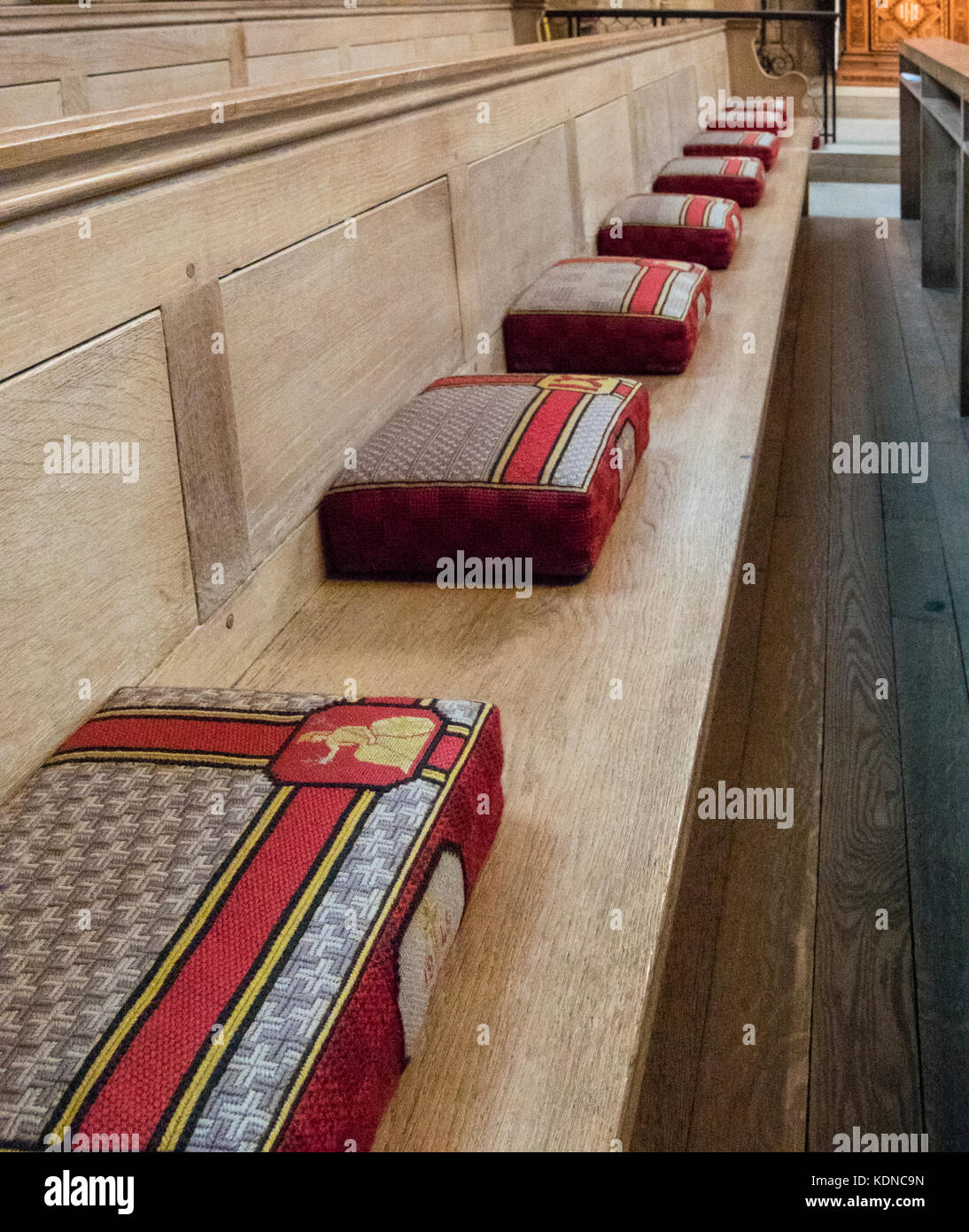 Eine Reihe von Gebet Kissen auf eine Kirchenbank in der Kathedrale von Norwich, Norfolk, Großbritannien Stockfoto
