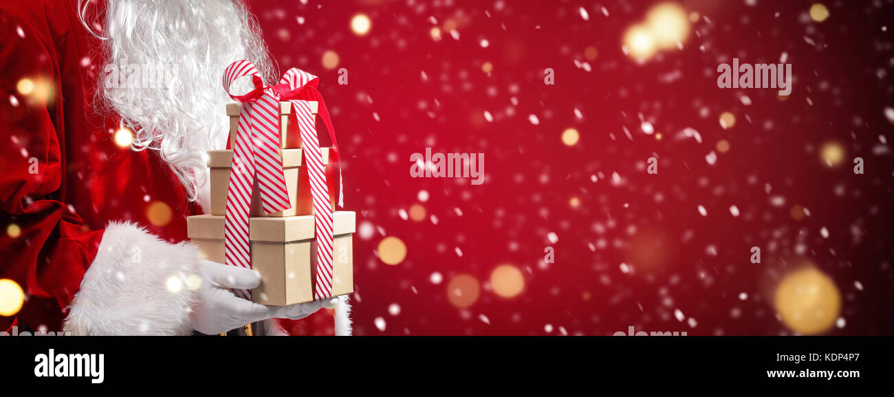 Santa claus Holding Geschenkboxen mit Weihnachtsbeleuchtung. Stockfoto