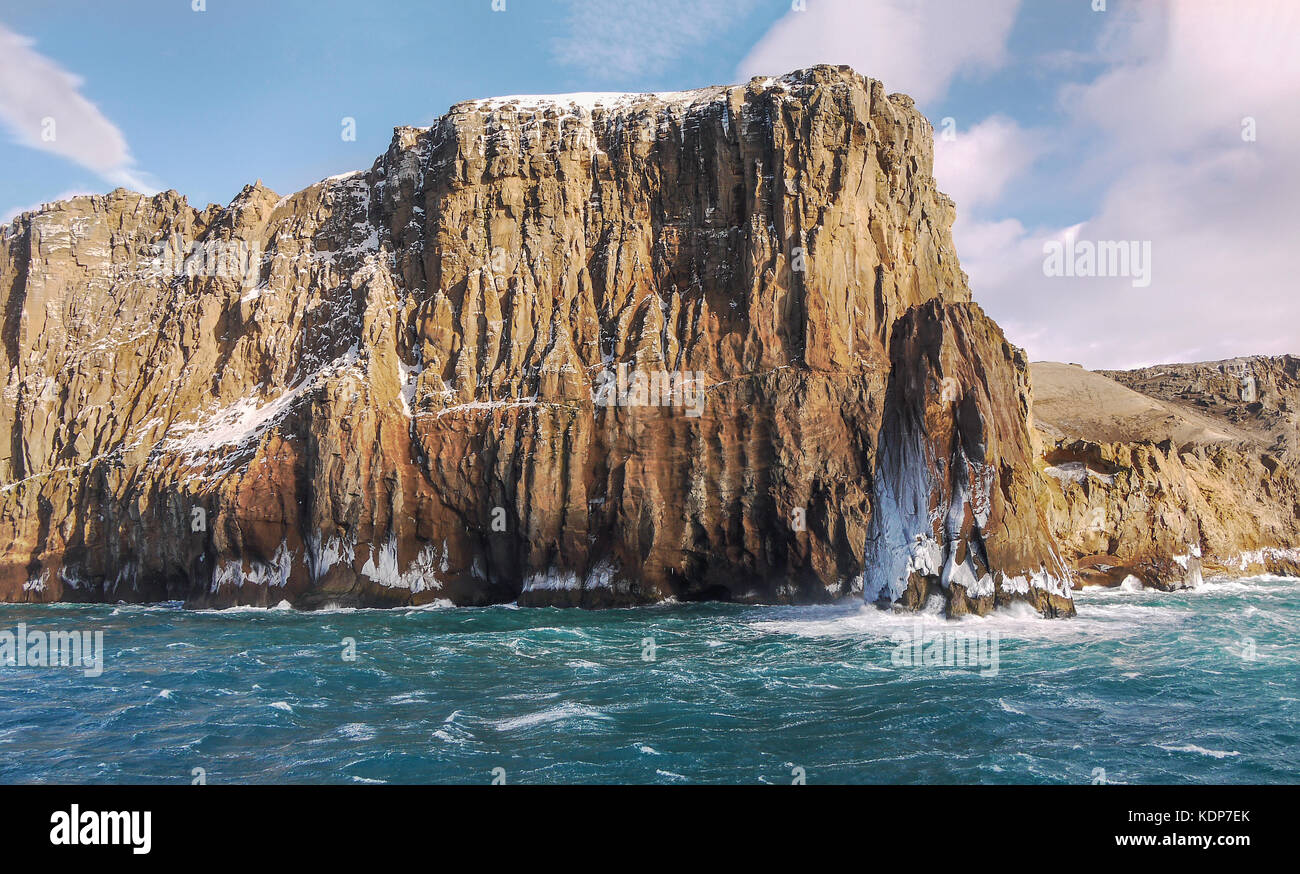 In der Nähe von felsigen Klippen und gefrorenen Meer in Neptuns Blasebalg, Deception Island, South Shetland Islands, Antarktis stack. Stockfoto