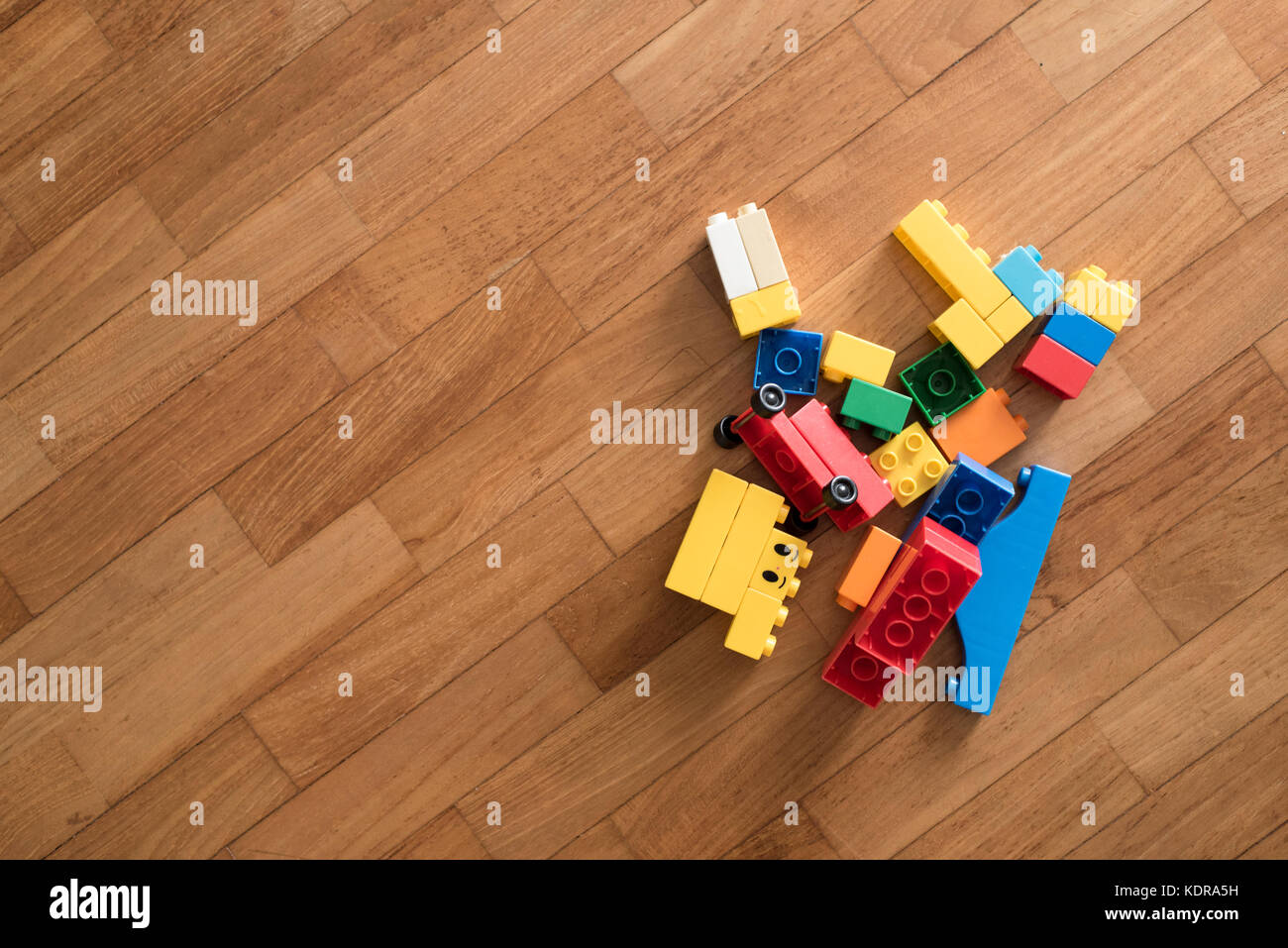 Spielzeug Ziegelsteine auf Holzboden. bunten Kunststoff Bausteine. Kindheit Bildung Konzept Stockfoto