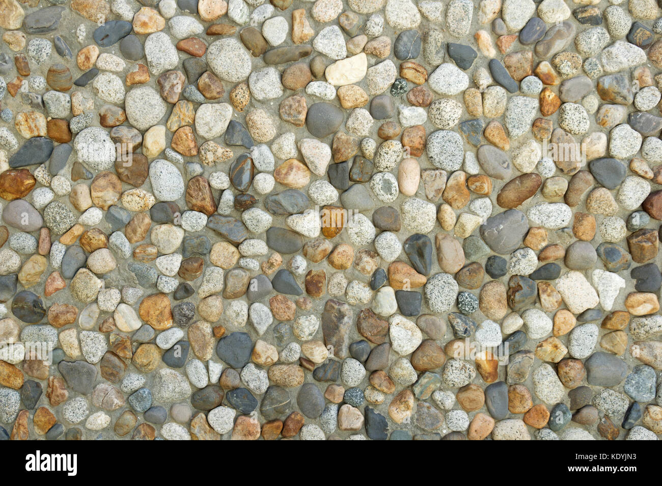 Betonwand mit Gewaschenen cobble Textur Hintergrund Stockfoto