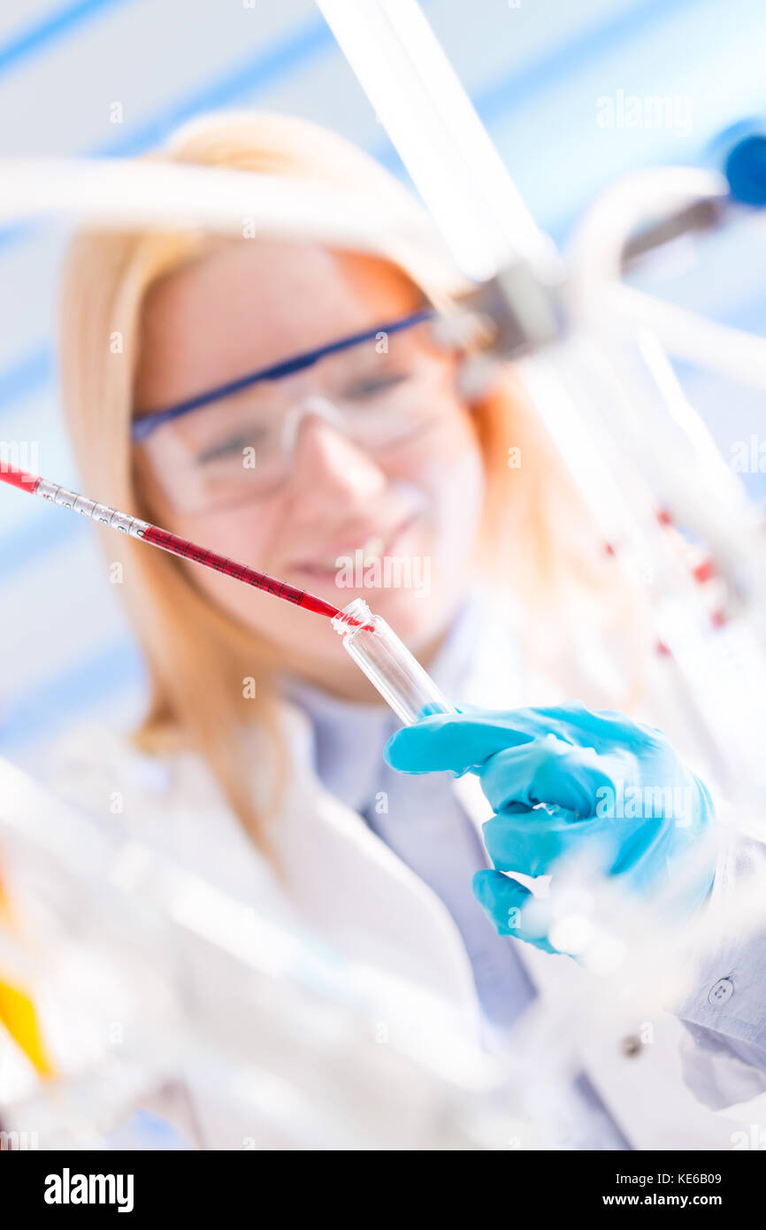 Weibliche Laboratory Assistant mit chemischen Experiment im wissenschaftlichen Labor Stockfoto