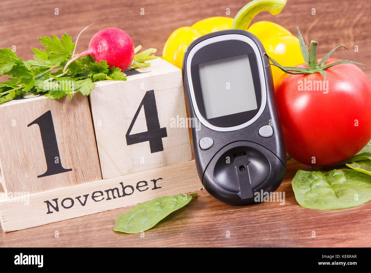 Datum 14. November als Symbol der Weltdiabetestag, glucometer für die Messung von Blutzucker und Gemüse, Konzept der Bekämpfung von Krankheiten Stockfoto
