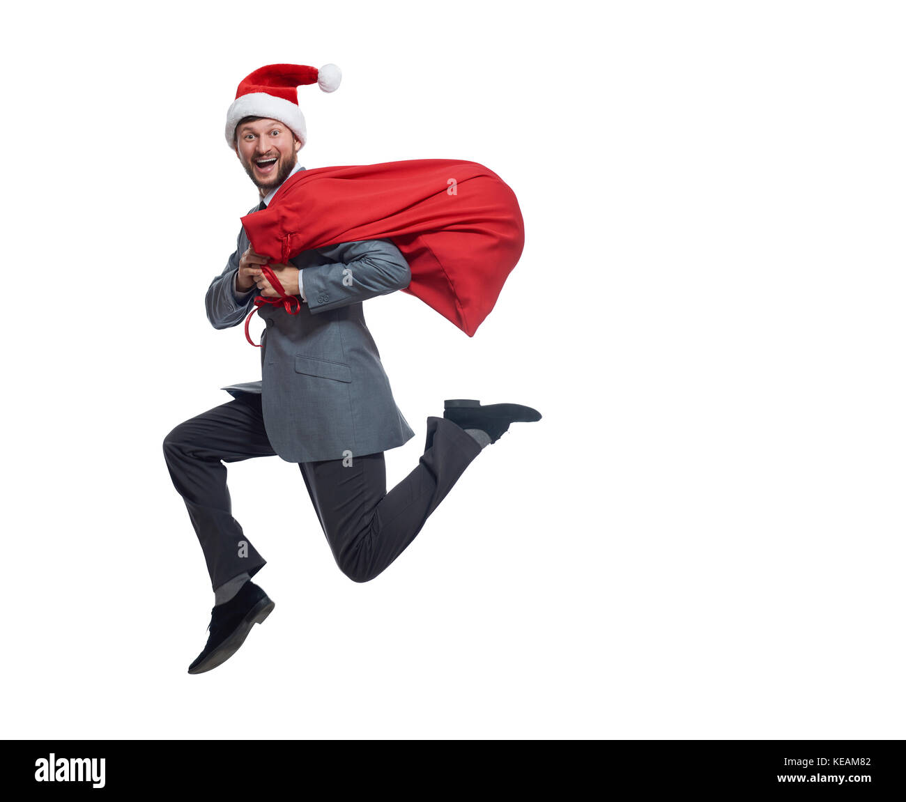 Santa Clause springen mit Tasche Geschenke und Geschenke. Stockfoto