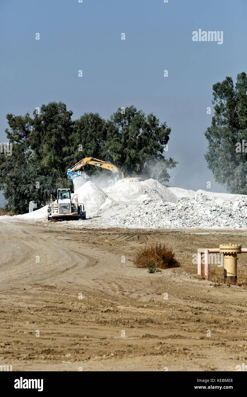 Caterpillar 320C Traktor, schwingende Ausleger, die Verwertung gebrauchter sheetrock Verkleidungen. Stockfoto