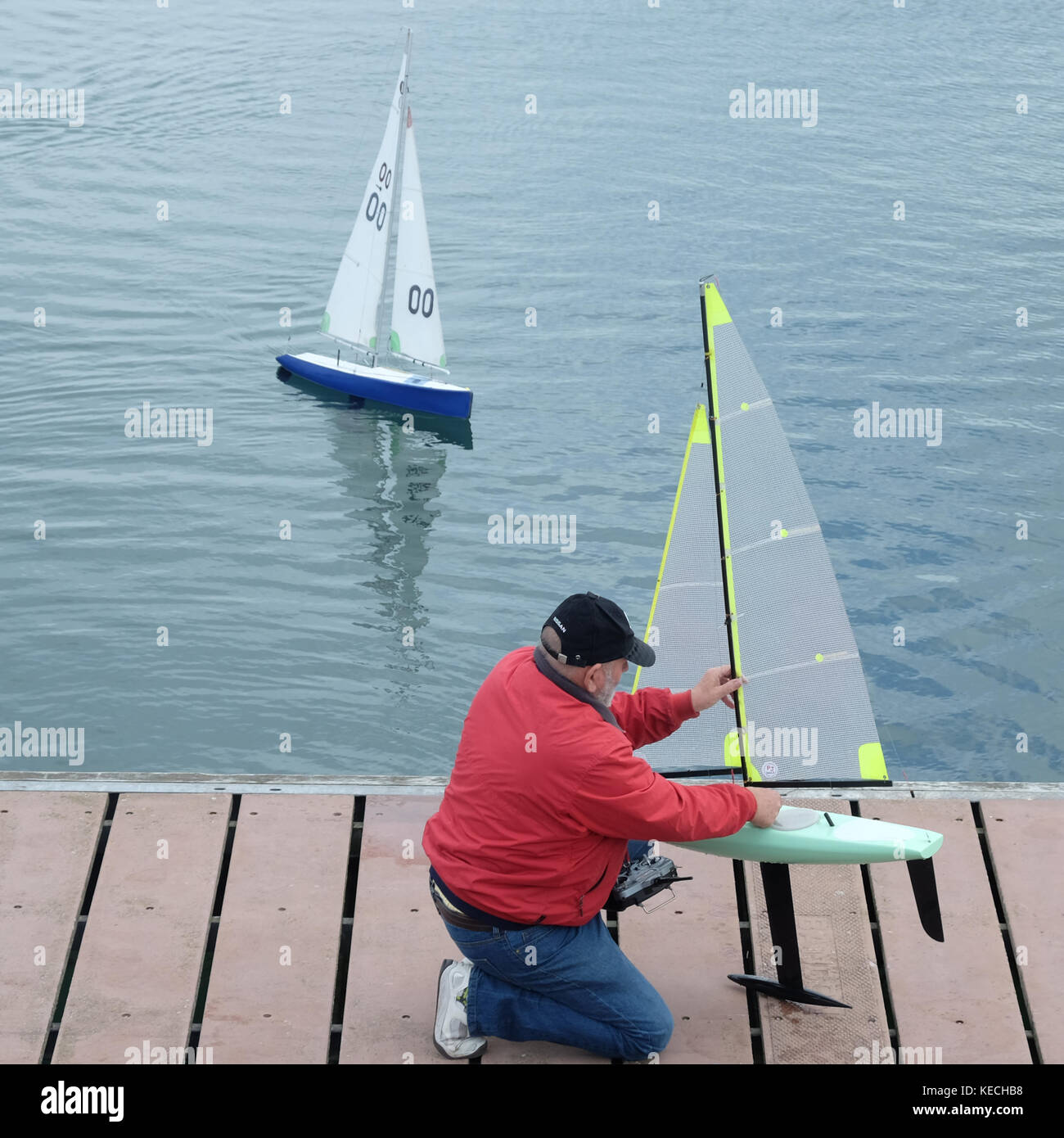 Man segeln Modell Yachten, Carrickfergus Hafen Stockfoto