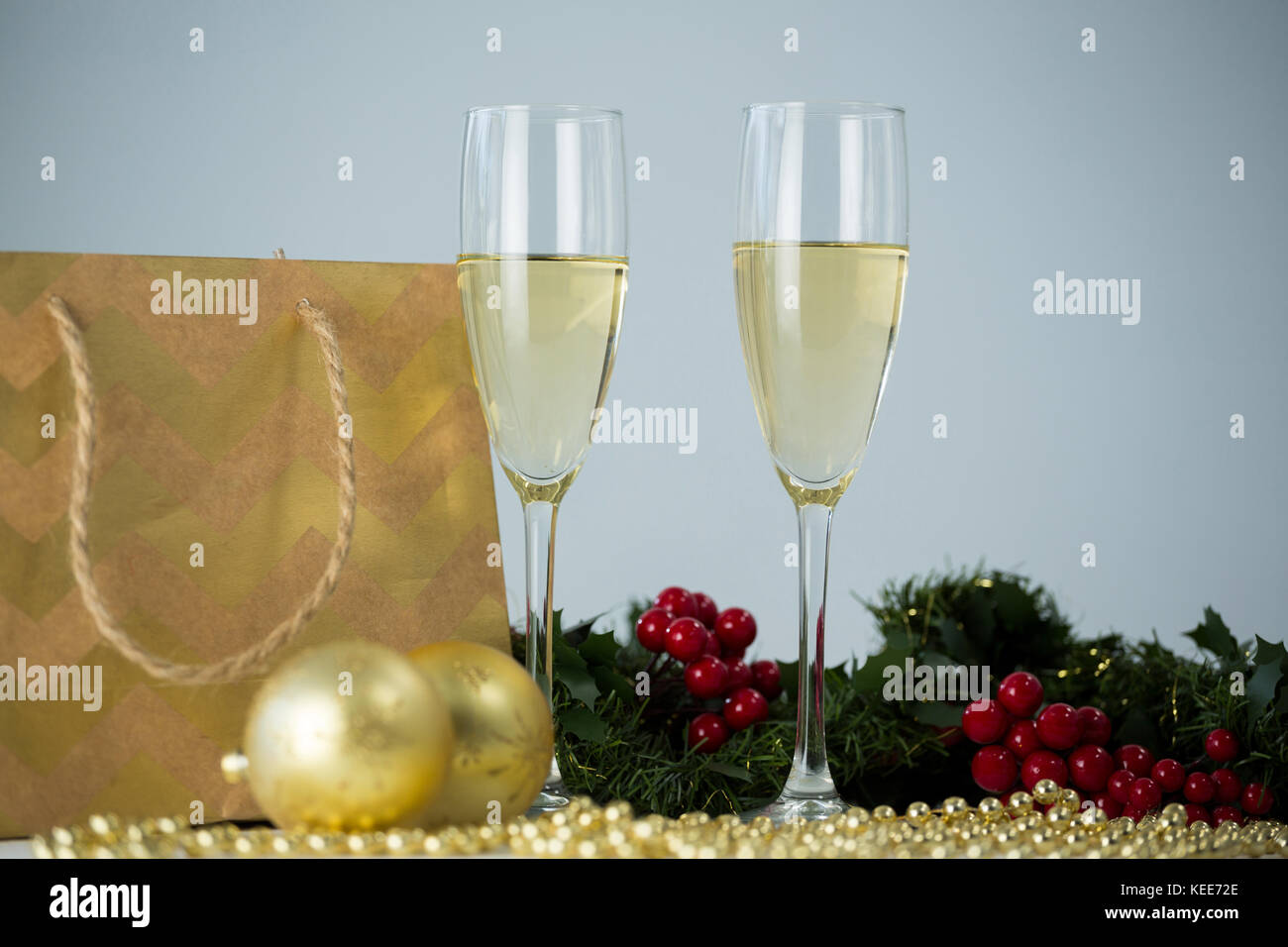 Close-up Champagner Flöte und Weihnachten Dekoration vor weißem Hintergrund Stockfoto