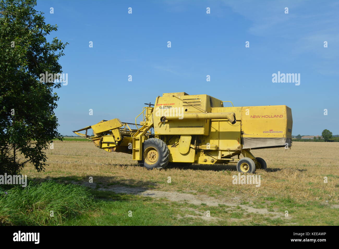 Alte offene Kabine gelb New Holland Mähdrescher Erntegut auf einem englischen Farm in 2017 Stockfoto