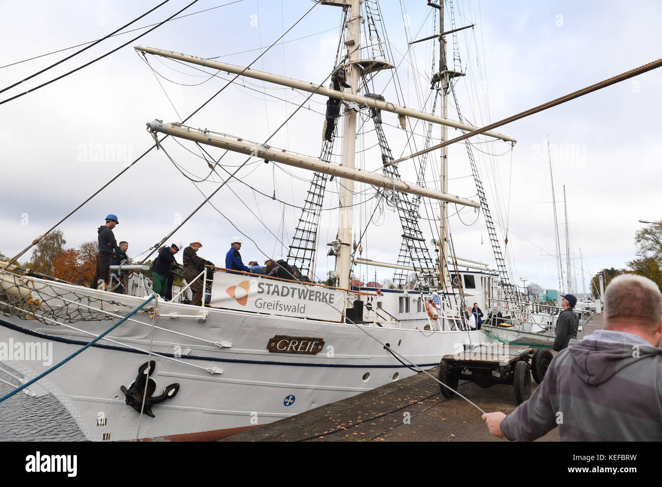 Greifswald, Deutschland. Oktober 2017. Das Segelschulschiff „Greif“ wird am 21. Oktober 2017 im Hafen Wieck bei Greifswald abgehängt. Bis zu 100 Freiwillige nehmen an den traditionellen Abtakeln des ehemaligen Segelschulschiffs der DDR Teil. Die Greif war in diesem Jahr 126 Tage in Betrieb und legte rund 5.350 Seemeilen zurück. Quelle: Stefan sauer/dpa/Alamy Live News Stockfoto